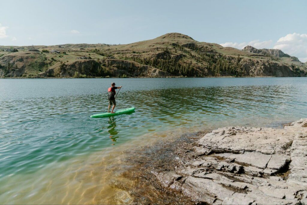 Man Paddle-boarding in Kalamalka Lake Paddle Trail